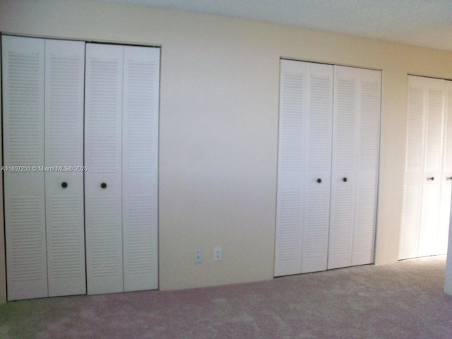 200 SE 5th Ave Unit 507, Dania Beach, FL 33004 - unfurnished bedroom with multiple closets and carpet floors