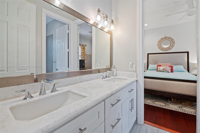 13990 SW 41st St, Davie, FL 33330 - bathroom featuring double vanity, ensuite bathroom, and wood finished floors