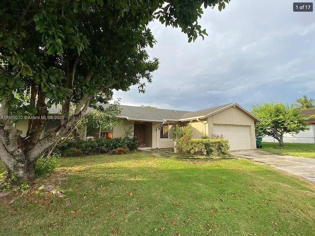 9315 SW 170th Ln, Palmetto Bay, FL 33157 - ranch-style home with an attached garage, driveway, a front lawn, and stucco siding