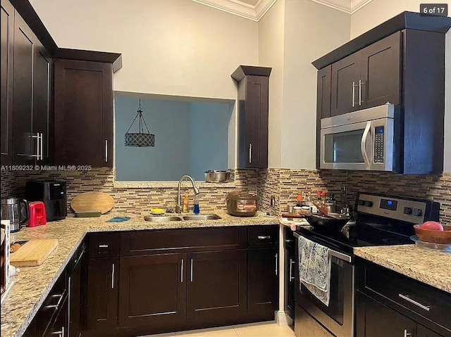 9315 SW 170th Ln, Palmetto Bay, FL 33157 - kitchen with appliances with stainless steel finishes, a sink, ornamental molding, backsplash, and light stone counters