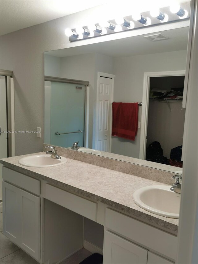 2116 5th Pl, Cape Coral, FL 33909 - full bath with double vanity, a spacious closet, and a shower stall