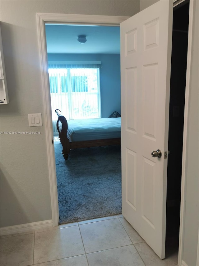 2116 5th Pl, Cape Coral, FL 33909 - hallway featuring light carpet, baseboards, and light tile patterned floors