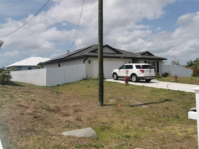 2116 5th Pl, Cape Coral, FL 33909 - view of property exterior with a garage and driveway