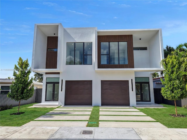 2839 SW 25th St, Miami, FL 33133 - modern home with driveway, an attached garage, stucco siding, and french doors