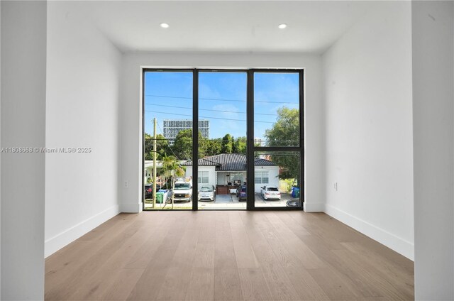 2839 SW 25th St, Miami, FL 33133 - empty room featuring healthy amount of natural light, wood finished floors, baseboards, and recessed lighting