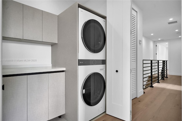 2839 SW 25th St, Miami, FL 33133 - laundry room with stacked washer / dryer, wood finished floors, and recessed lighting