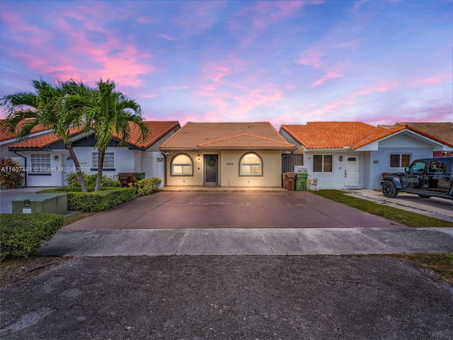 5650 W 21st Ave, Hialeah, FL 33016 - view of front facade featuring a tile roof, stucco siding, and driveway