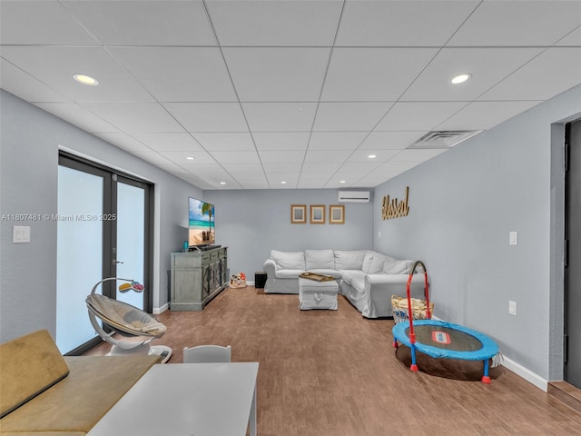 5650 W 21st Ave, Hialeah, FL 33016 - living area featuring recessed lighting, wood finished floors, baseboards, a wall mounted AC, and a drop ceiling