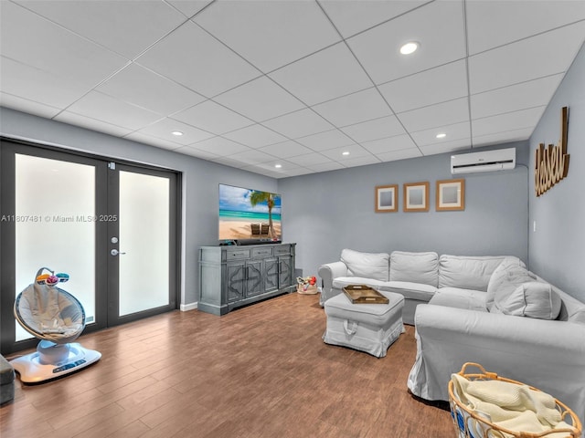 5650 W 21st Ave, Hialeah, FL 33016 - living area featuring a wall mounted air conditioner, wood finished floors, a paneled ceiling, recessed lighting, and baseboards