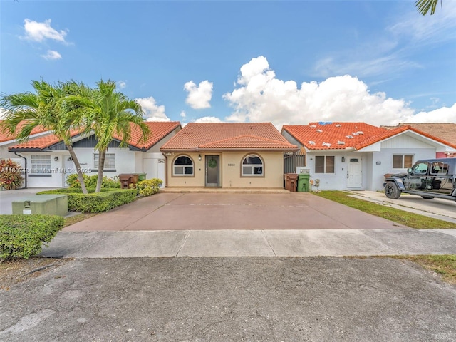 5650 W 21st Ave, Hialeah, FL 33016 - view of front facade featuring a tile roof, stucco siding, and concrete driveway