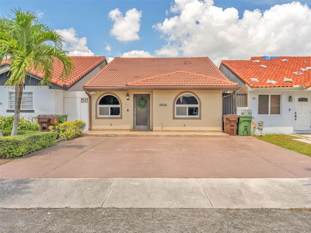 5650 W 21st Ave, Hialeah, FL 33016 - view of front facade with a tiled roof and stucco siding