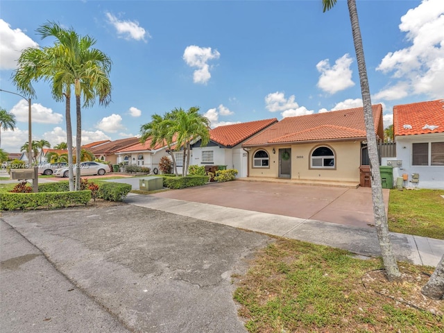 5650 W 21st Ave, Hialeah, FL 33016 - mediterranean / spanish house with driveway, a tile roof, and stucco siding