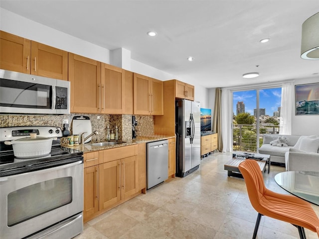 945 Michigan Ave Unit 8, Miami Beach, FL 33139 - kitchen with appliances with stainless steel finishes, decorative backsplash, light stone countertops, recessed lighting, and a sink