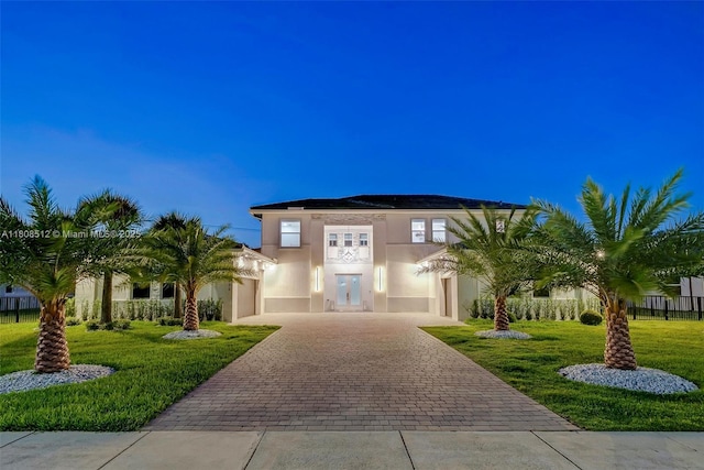 11035 N Sierra Ranch Dr, Davie, FL 33324 - view of front facade featuring decorative driveway, a front lawn, and stucco siding
