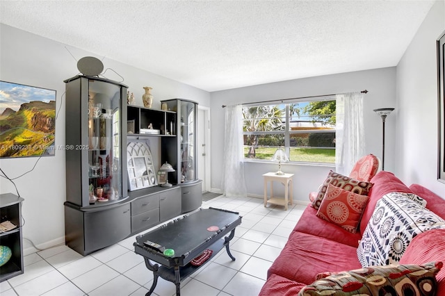 4441 NW 16th St Unit J108, Lauderhill, FL 33313 - tiled living room with a textured ceiling and baseboards