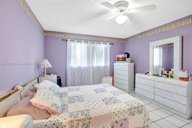 4441 NW 16th St Unit J108, Lauderhill, FL 33313 - bedroom with multiple windows, a ceiling fan, and tile patterned flooring