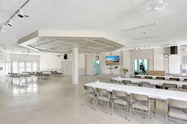 4441 NW 16th St Unit J108, Lauderhill, FL 33313 - dining space featuring track lighting and a textured ceiling