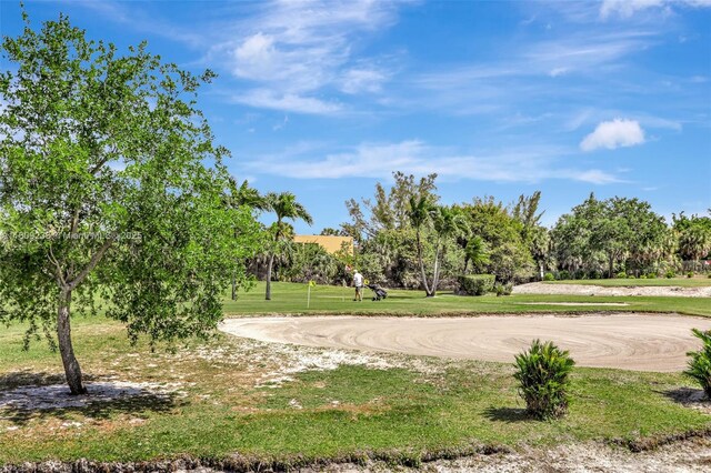 4441 NW 16th St Unit J108, Lauderhill, FL 33313 - view of home's community featuring a yard and view of wooded area