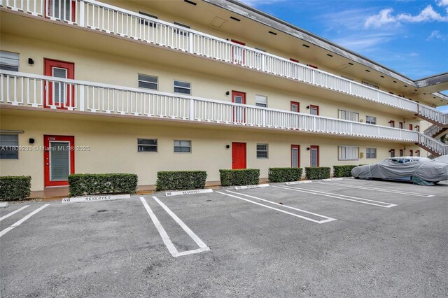 4441 NW 16th St Unit J108, Lauderhill, FL 33313 - view of property featuring uncovered parking