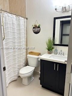 3801 SW 149th Ave, Miami, FL 33185 - full bath with toilet, vanity, and a shower with shower curtain