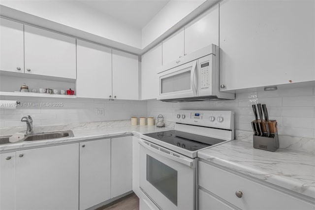1356 Pelican Ct, Homestead, FL 33035 - kitchen with white appliances, a sink, white cabinetry, and backsplash