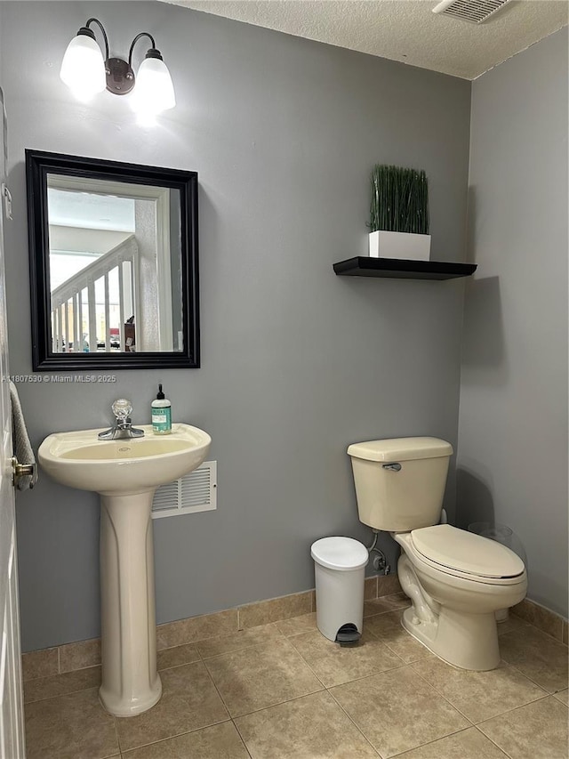 11921 SW 153rd Pl, Miami, FL 33196 - half bath featuring toilet, baseboards, tile patterned floors, and a textured ceiling