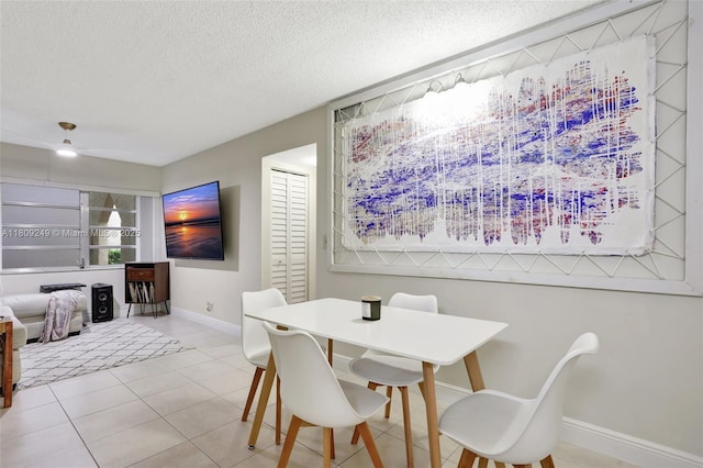 826 Twin Lakes Dr Unit 18-D, Coral Springs, FL 33071 - dining area with a textured ceiling and tile patterned flooring