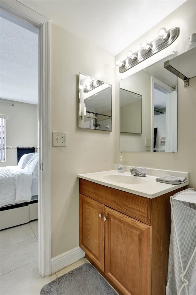 826 Twin Lakes Dr Unit 18-D, Coral Springs, FL 33071 - bathroom featuring ensuite bath, tile patterned flooring, and vanity
