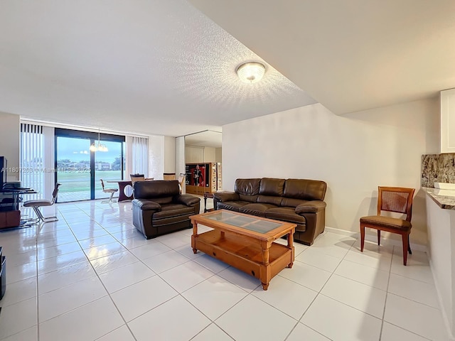 4545 Luxemburg Ct Unit 103, Lake Worth, FL 33467 - living room with light tile patterned floors, a textured ceiling, and floor to ceiling windows