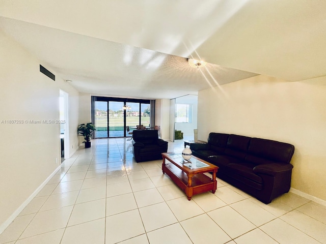 4545 Luxemburg Ct Unit 103, Lake Worth, FL 33467 - living area with healthy amount of natural light, baseboards, and light tile patterned flooring