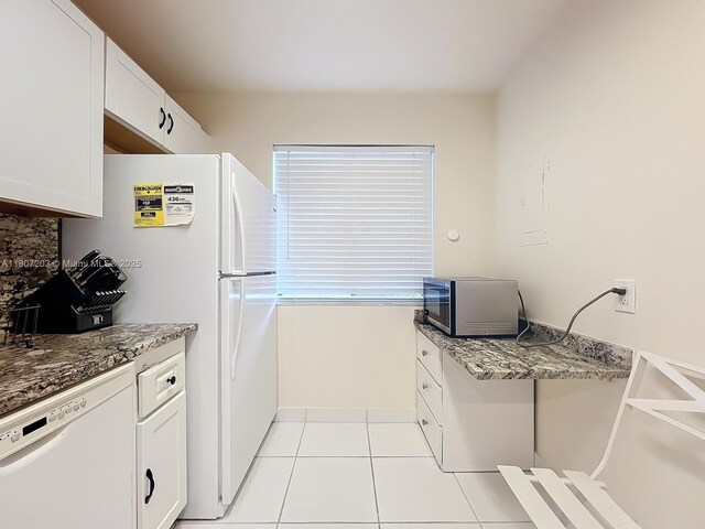 4545 Luxemburg Ct Unit 103, Lake Worth, FL 33467 - kitchen with white appliances, light tile patterned flooring, and white cabinets