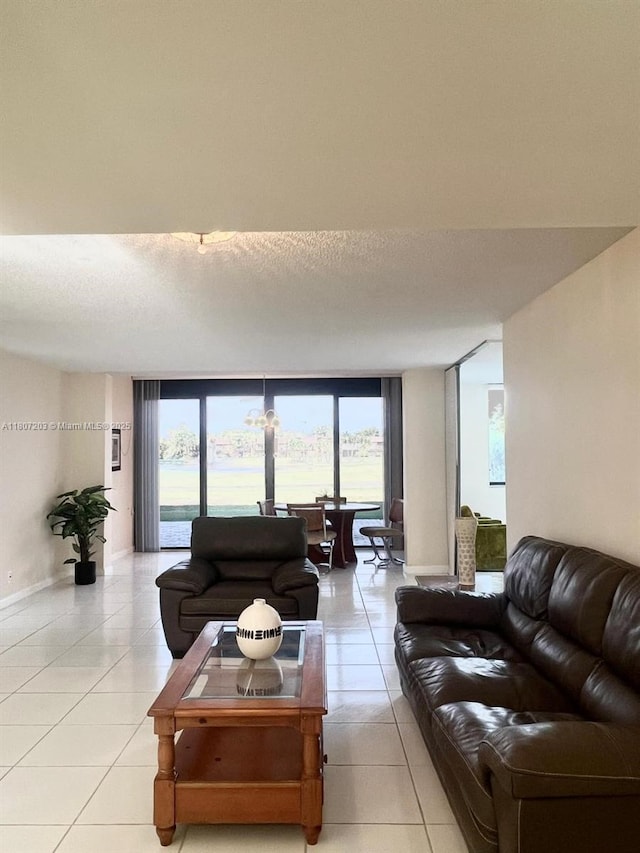 4545 Luxemburg Ct Unit 103, Lake Worth, FL 33467 - living room featuring light tile patterned flooring, healthy amount of natural light, and baseboards
