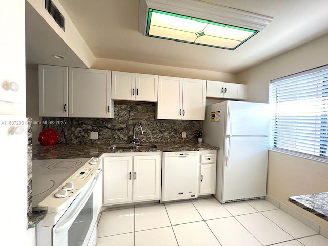 4545 Luxemburg Ct Unit 103, Lake Worth, FL 33467 - kitchen featuring white appliances, a sink, backsplash, and white cabinetry