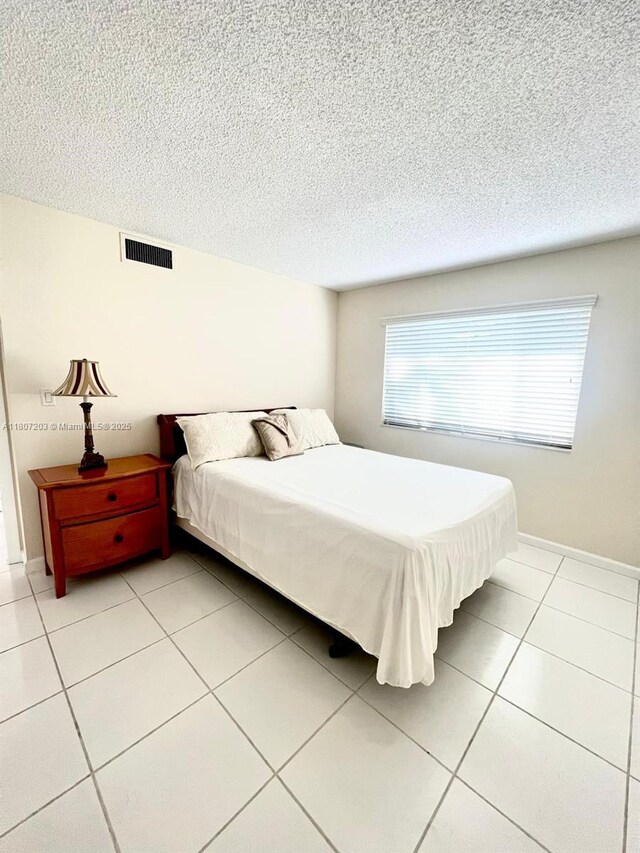 4545 Luxemburg Ct Unit 103, Lake Worth, FL 33467 - bedroom featuring light tile patterned floors and a textured ceiling
