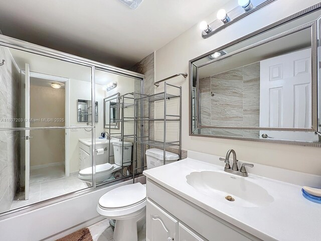 4545 Luxemburg Ct Unit 103, Lake Worth, FL 33467 - bathroom with vanity, toilet, and bath / shower combo with glass door