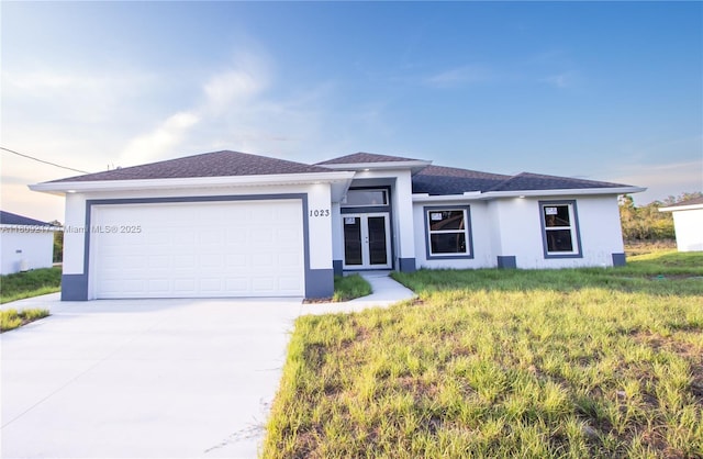 1023 Pilgrim, Lehigh Acres, FL 33974 - view of front facade featuring french doors, stucco siding, driveway, and an attached garage