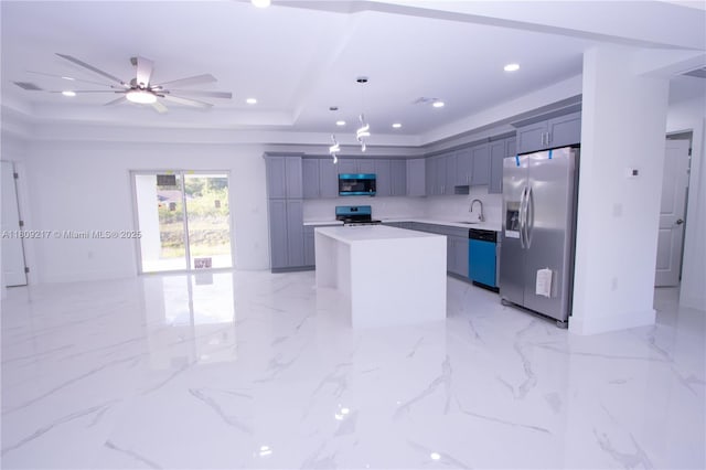 1023 Pilgrim, Lehigh Acres, FL 33974 - kitchen with stainless steel appliances, a raised ceiling, a kitchen island, light countertops, and a sink