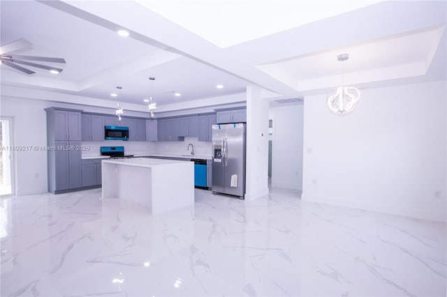 1023 Pilgrim, Lehigh Acres, FL 33974 - kitchen featuring appliances with stainless steel finishes, a raised ceiling, light countertops, a kitchen island, and recessed lighting