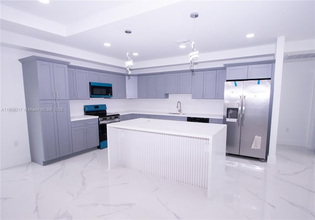 1023 Pilgrim, Lehigh Acres, FL 33974 - kitchen with appliances with stainless steel finishes, a sink, a kitchen island, light countertops, and hanging light fixtures