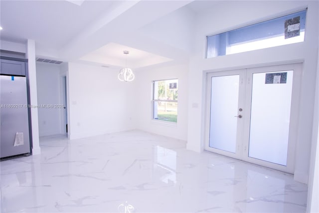 1023 Pilgrim, Lehigh Acres, FL 33974 - foyer entrance featuring light marble finish flooring, french doors, and a chandelier