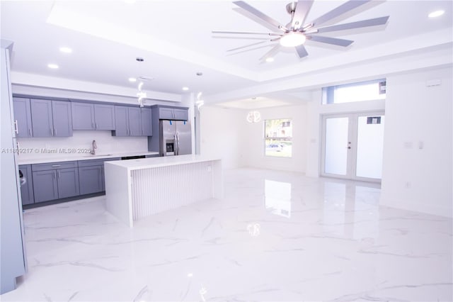 1023 Pilgrim, Lehigh Acres, FL 33974 - kitchen featuring stainless steel refrigerator with ice dispenser, a sink, recessed lighting, light countertops, and open floor plan