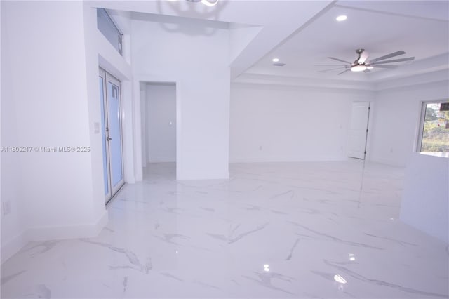1023 Pilgrim, Lehigh Acres, FL 33974 - spare room featuring recessed lighting, a tray ceiling, baseboards, light marble finish floors, and a ceiling fan