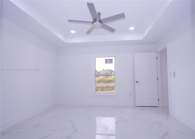 1023 Pilgrim, Lehigh Acres, FL 33974 - unfurnished room featuring a tray ceiling, baseboards, recessed lighting, ceiling fan, and light marble finish floors