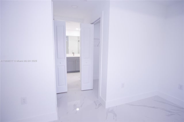 1023 Pilgrim, Lehigh Acres, FL 33974 - hall with light marble finish floors, baseboards, and a sink