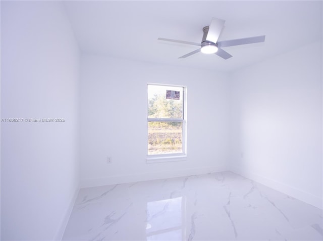 1023 Pilgrim, Lehigh Acres, FL 33974 - unfurnished room with baseboards, marble look tiles, and a ceiling fan