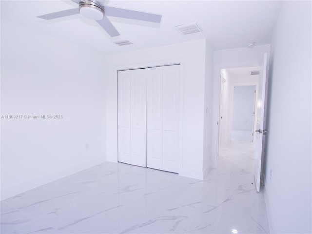 1023 Pilgrim, Lehigh Acres, FL 33974 - unfurnished bedroom with light marble finish floors, baseboards, and a closet