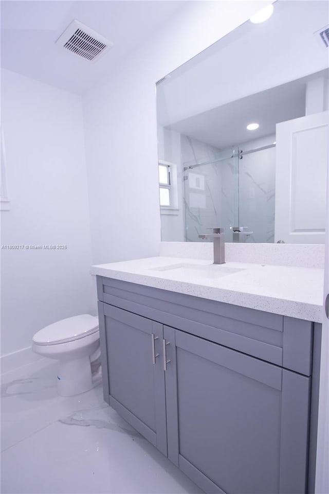 1023 Pilgrim, Lehigh Acres, FL 33974 - bathroom featuring marble look tile flooring, a marble finish shower, vanity, toilet, and recessed lighting