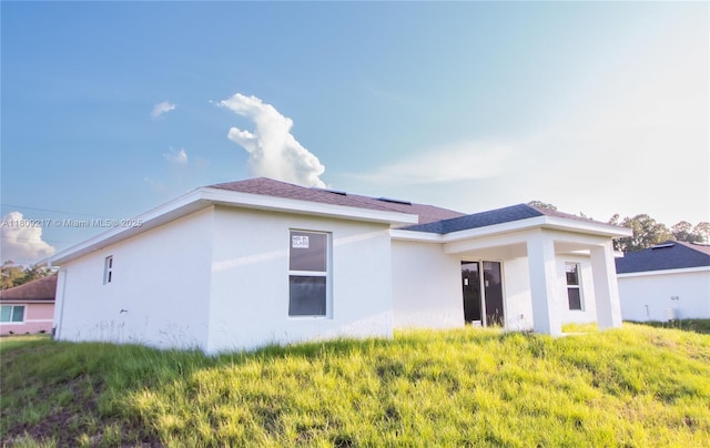1023 Pilgrim, Lehigh Acres, FL 33974 - back of house featuring stucco siding
