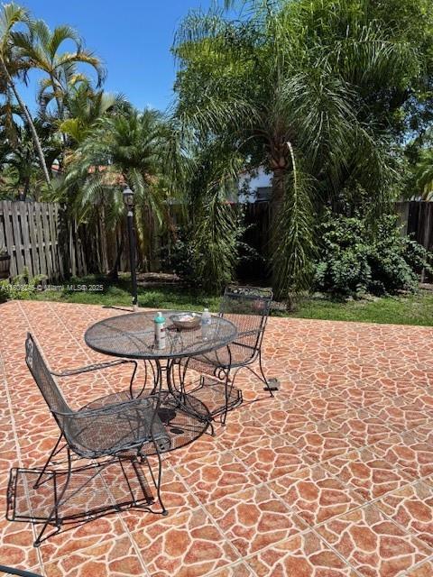 10813 SW 158th Ln, Miami, FL 33157 - fenced backyard featuring a patio area and outdoor dining space