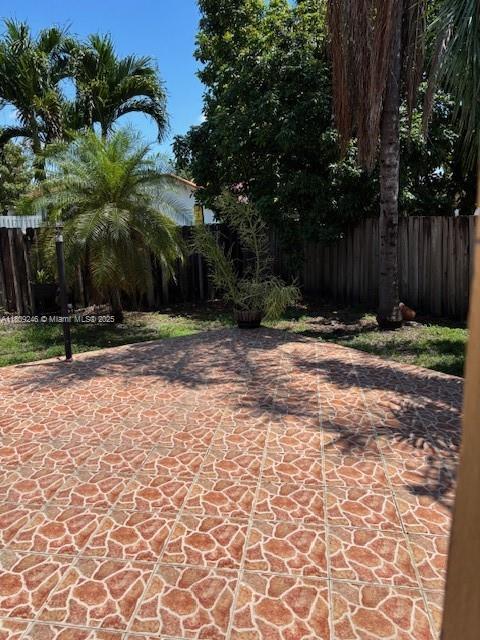 10813 SW 158th Ln, Miami, FL 33157 - fenced backyard featuring a patio area